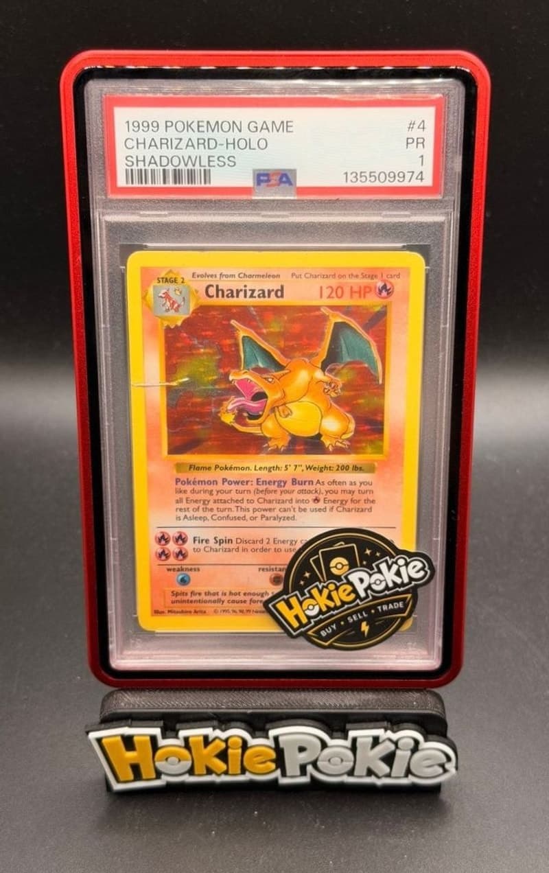 Charizard, PSA 1 graded, card 4 of 102 from the 1999 Base Set Pokémon TCG set. Actual photo of the card in hand.