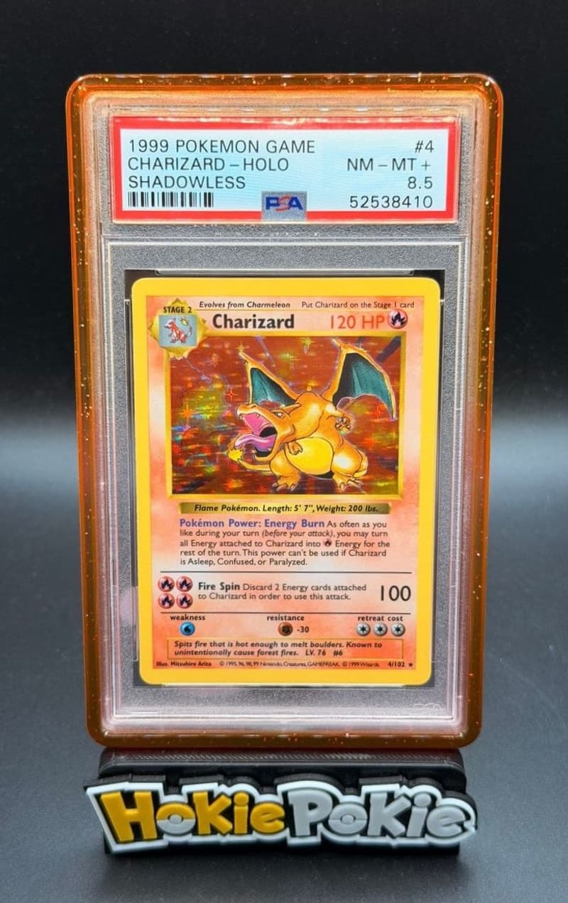 Charizard, PSA 8.5 graded, card 4 of 102 from the 1999 Base Set Pokémon TCG set. Actual photo of the card in hand.