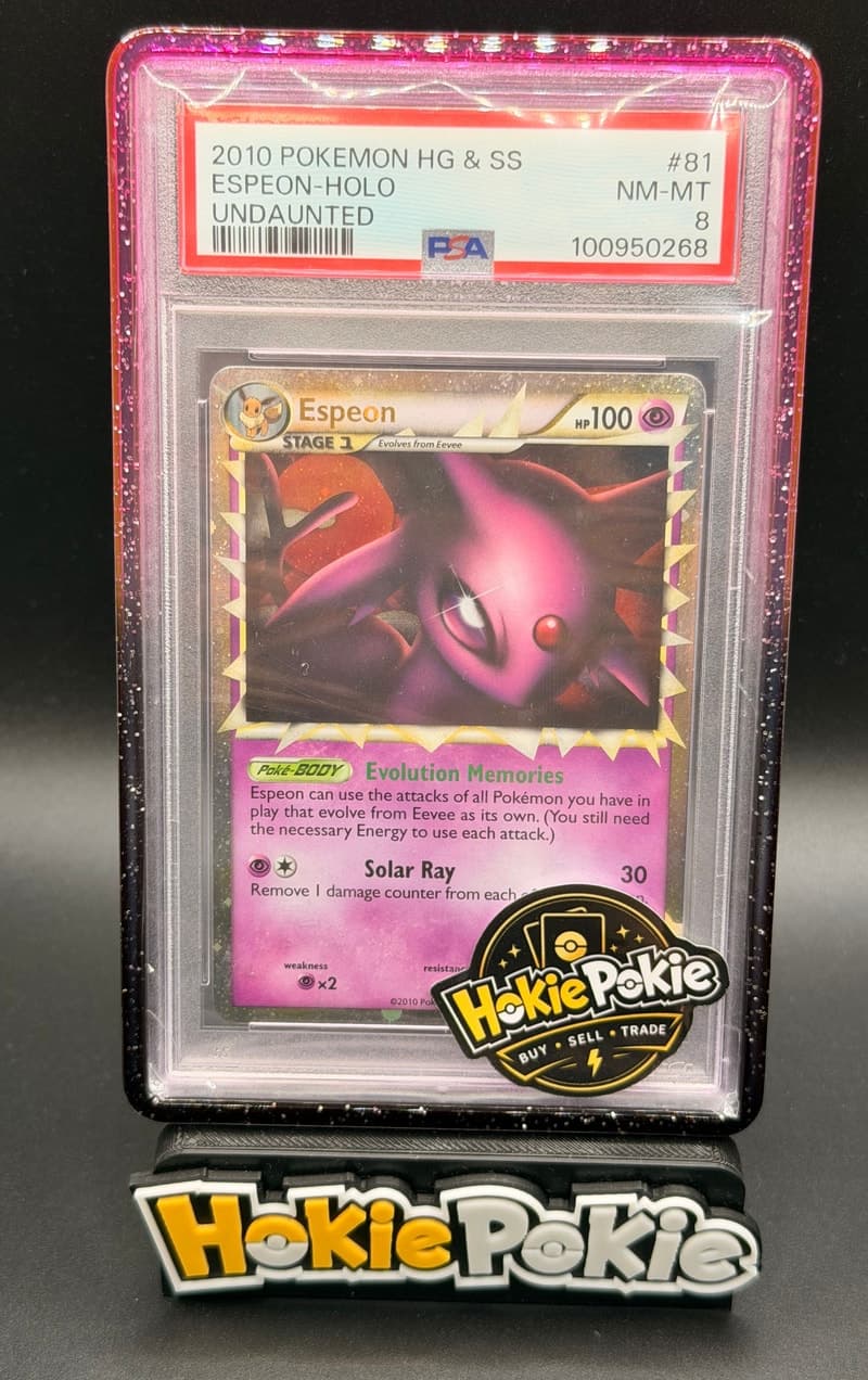 Espeon Prime, PSA 8 graded, card 81 of 90 from the 2010 HS Undaunted Pokémon TCG set. Actual photo of the card in hand.