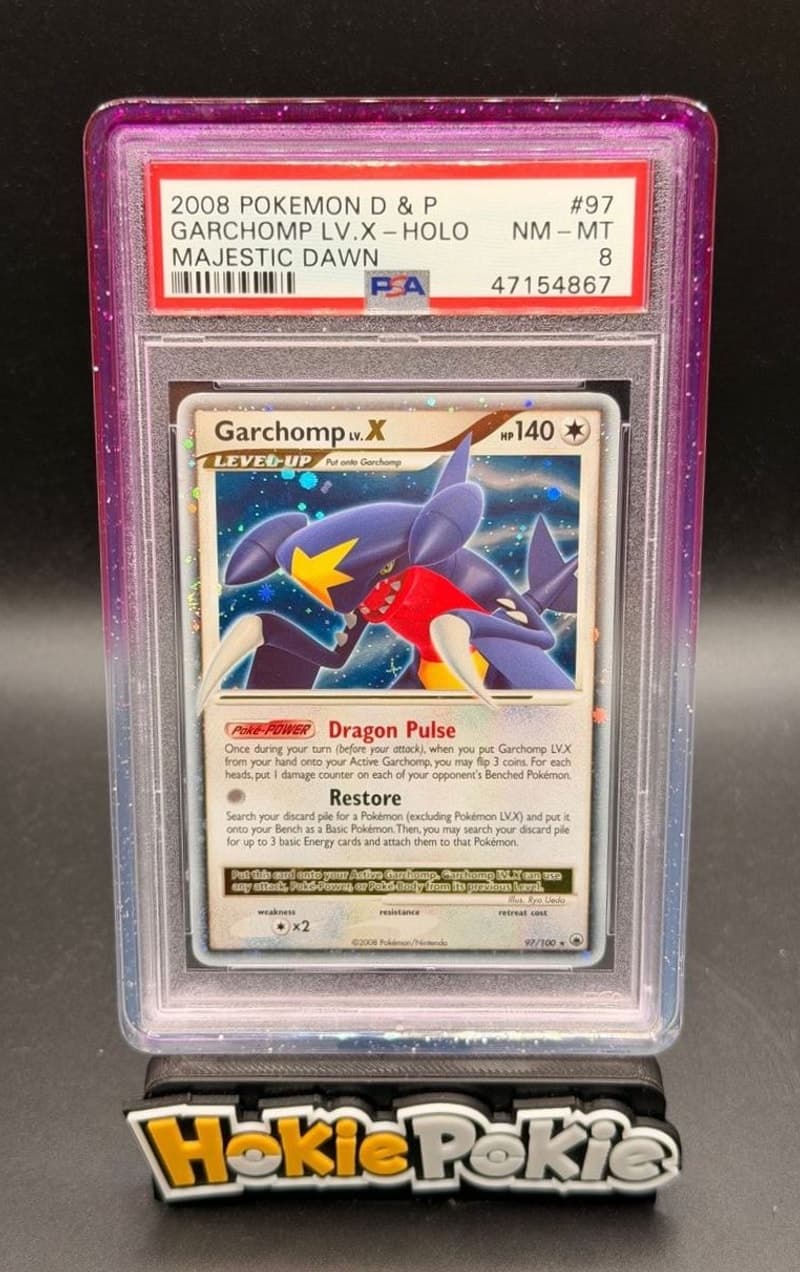 Garchomp LV.X, PSA 8 graded, card 97 of 100 from the 2008 Majestic Dawn Pokémon TCG set. Actual photo of the card in hand.