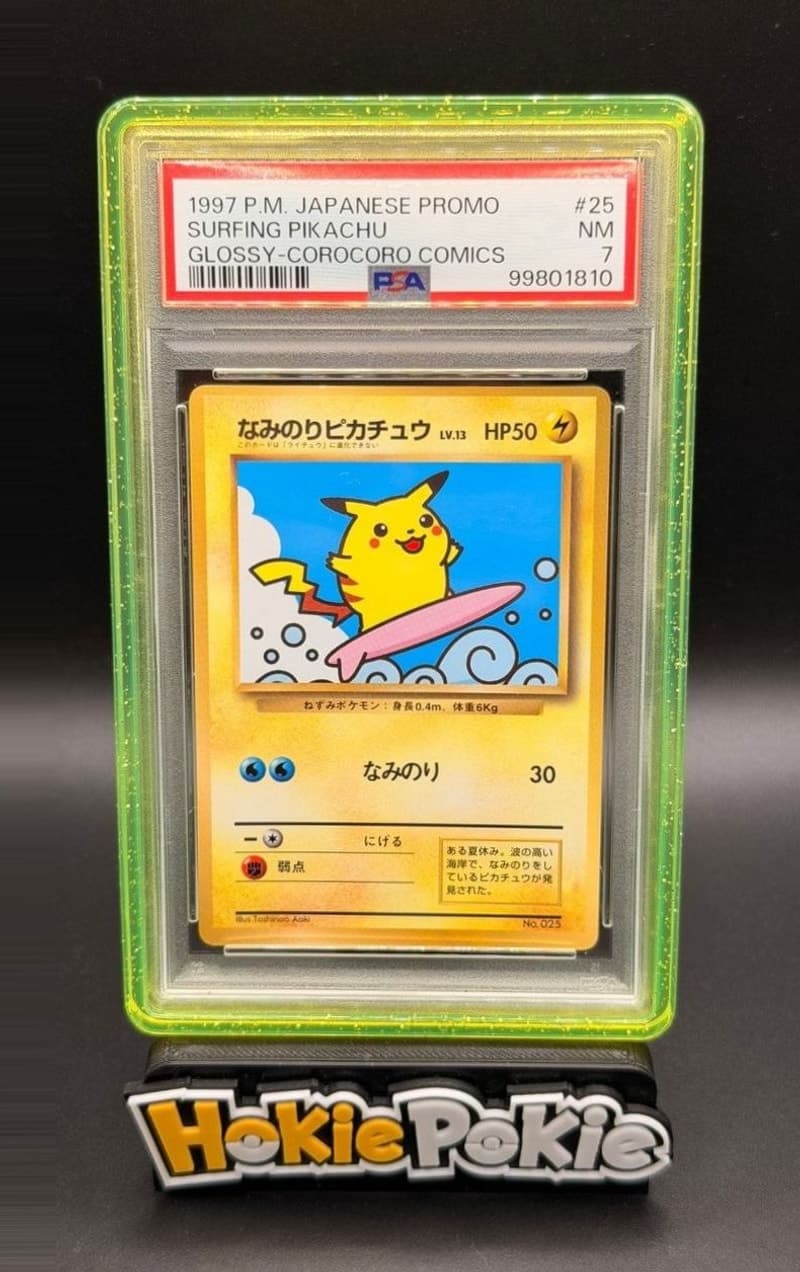 Surfing Pikachu, PSA 7 graded, card 25 from the 1997 CoroCoro Comics Promo (Japanese) Pokémon TCG set. Actual photo of the card in hand.